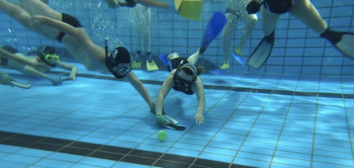 Image of people playing underwater hockey Image of people playing underwater hockey