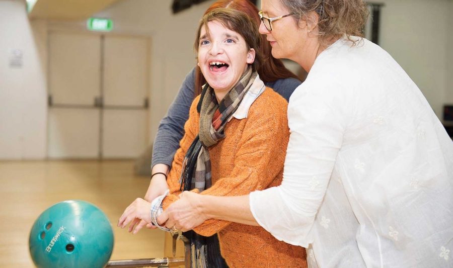 Teen with disability assisted at bowling centre. Teen with disability assisted at bowling centre.