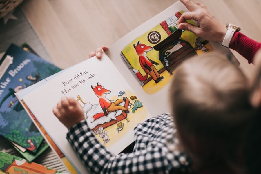 Child Reading Story Book With Adult Child reading story book with adult