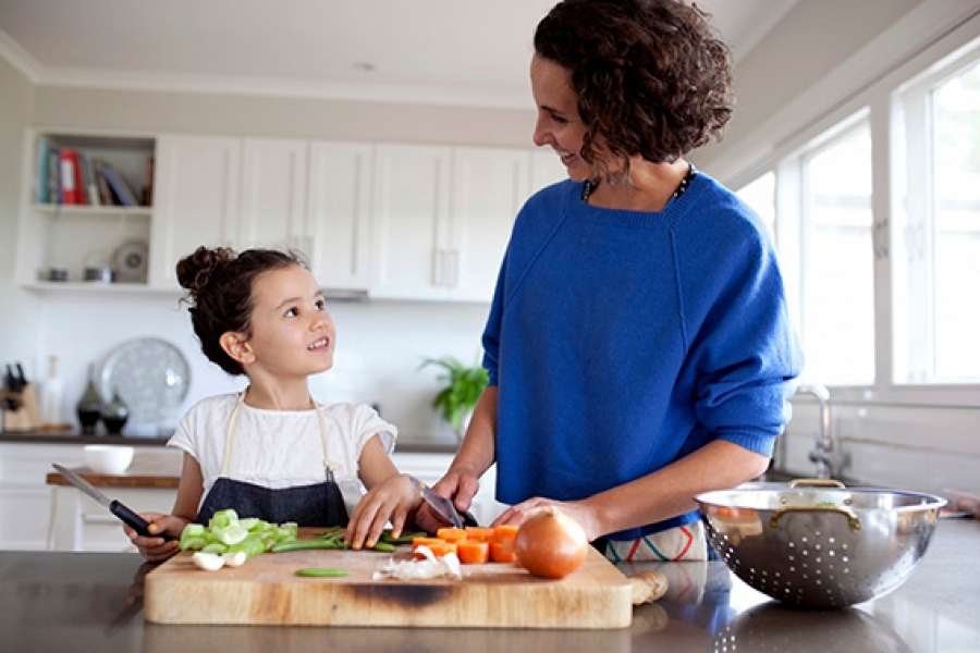 Mother and Child Baking Mother and daughter chopping vegetables together