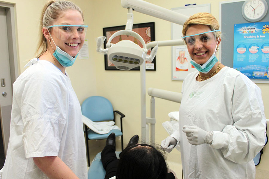 Dentist and Assistant smiling