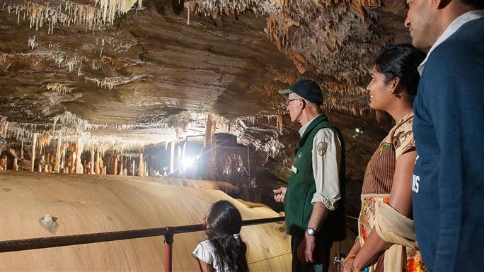 Image courtesy Visit Victoria Image of a family of 3 with a tour guide exploring Buchan Caves