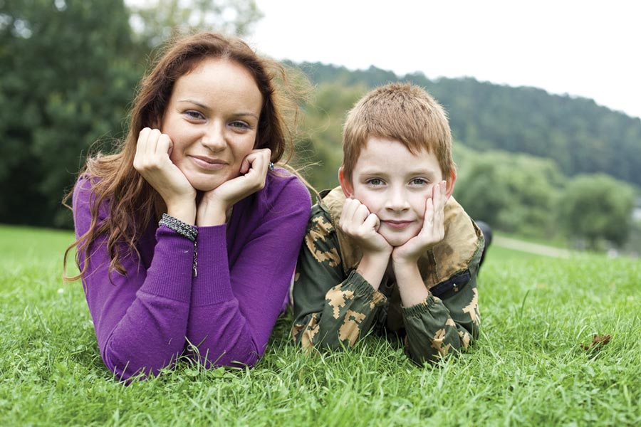 Mother and son lying on grass Mother and son lying on grass