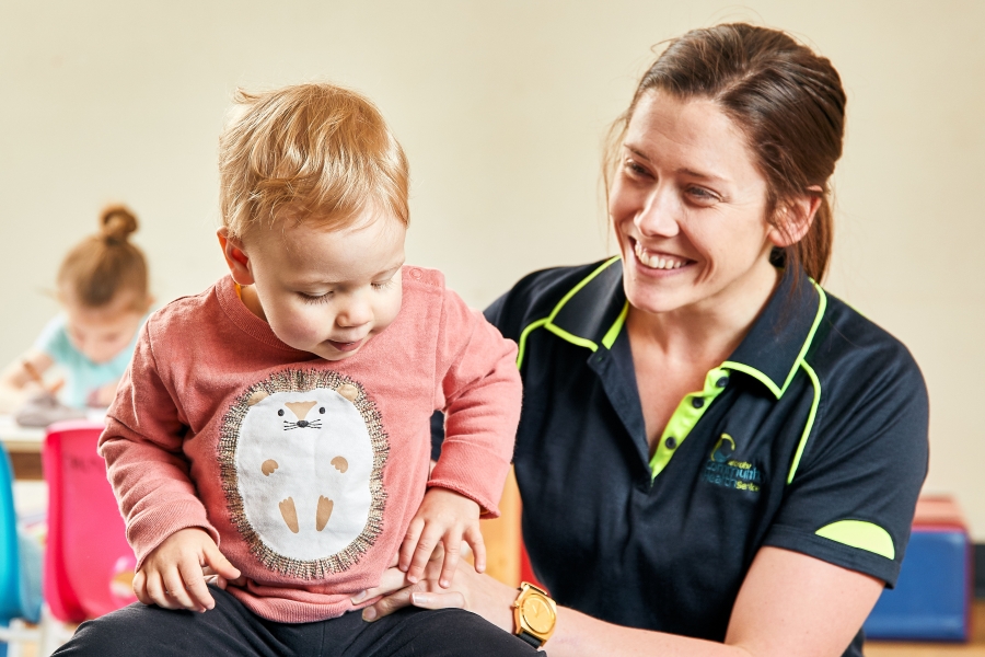 Fed_Uni_Gippsland_-_8th_October7598_GRIFFIN_SIMM_Finals Childcare worker holding child smiling