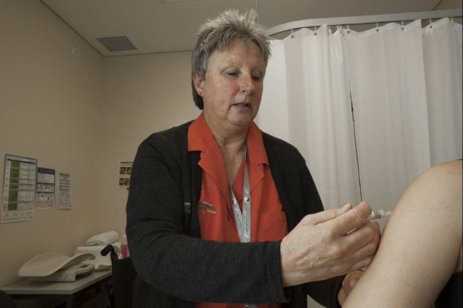 Nurse On Job Nurse injecting patient's shoulder