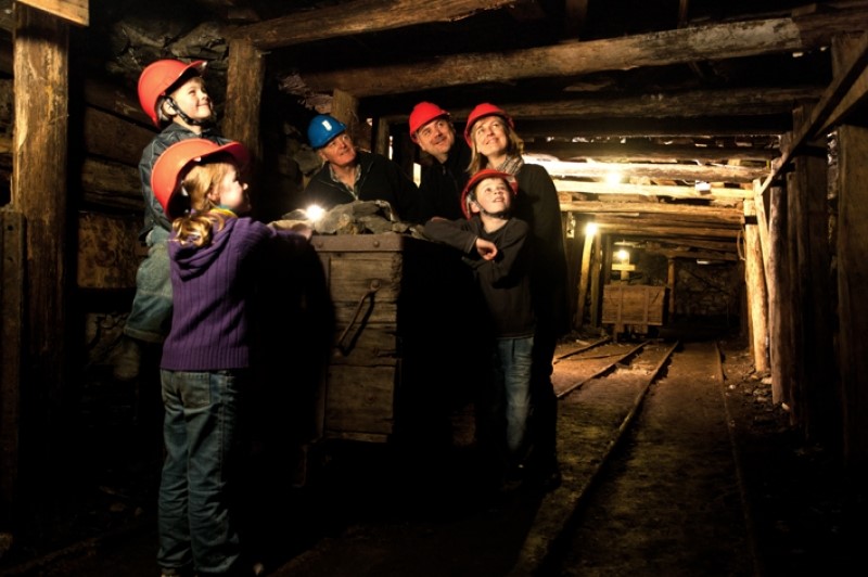 Image of a family undertaking a tour underground in a coal mine