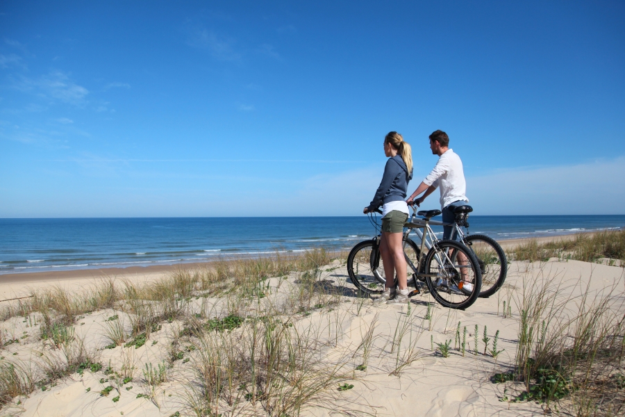 Bikers on the Beach Biker couple staring at waves on the beach
