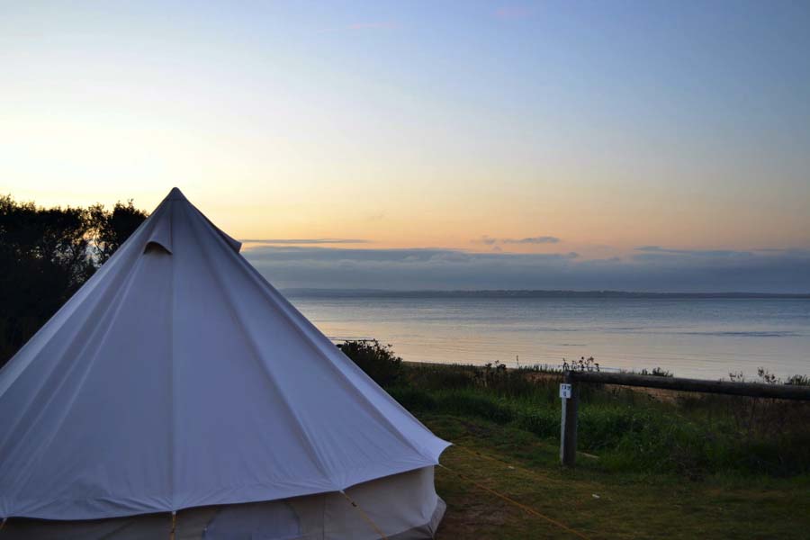 Image courtesy of Phillip Island Glamping Image of glamping tent exterior over looking body of water at Phillip Island