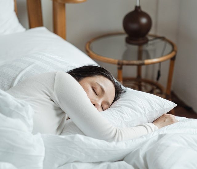 A women sleeping in white sheets