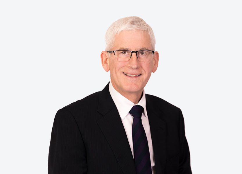 Stelvio Headshot of board member Stelvio Vido, smiling wearing glasses and a black suit and tie
