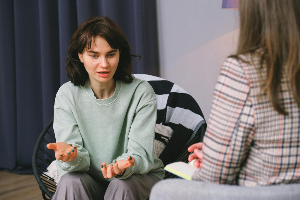a young woman talking to a counsellor