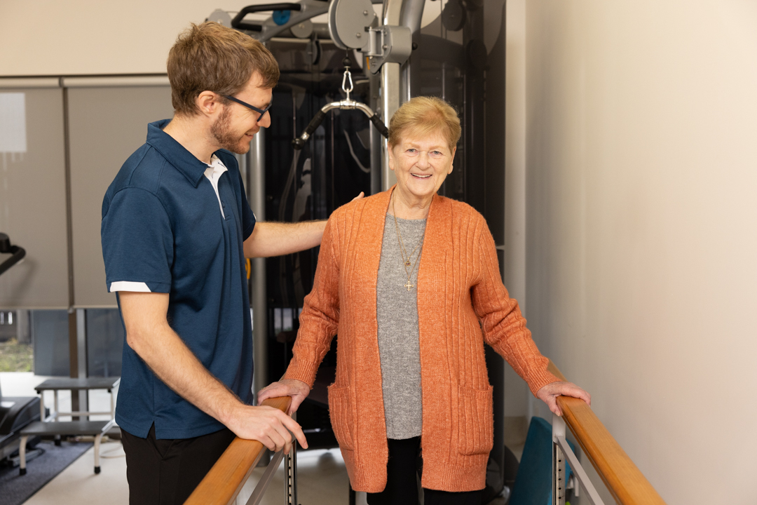 LCHS staff member assisting a client with exercise