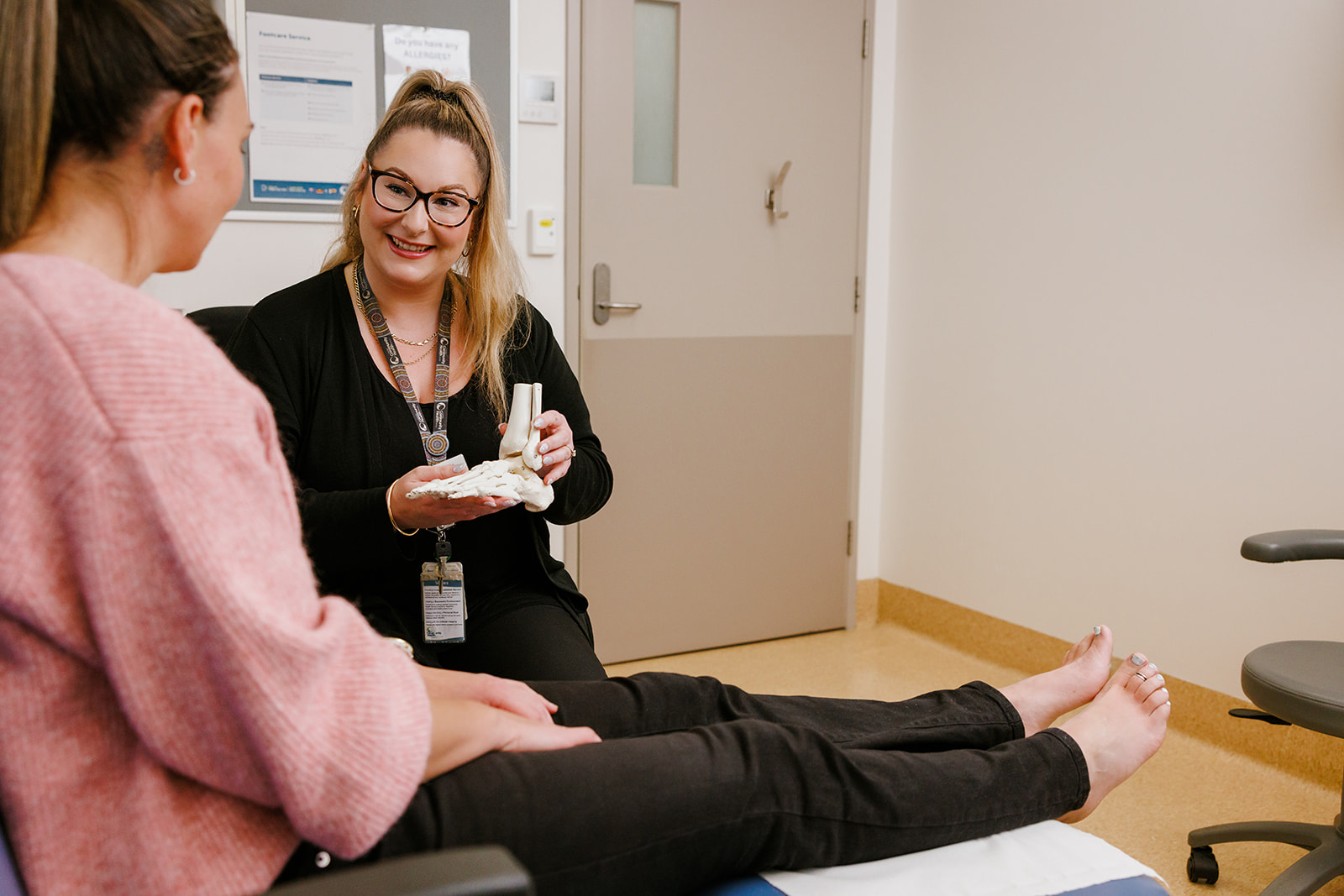 Podiatrist and client in a treatment room