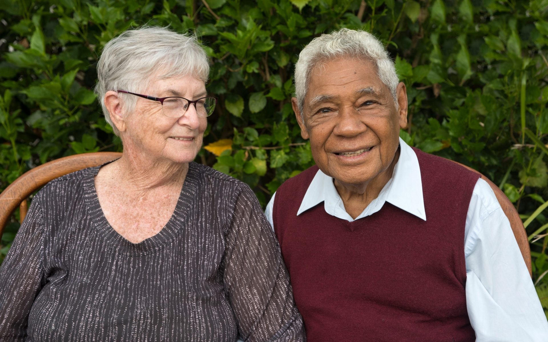 A woman and a man sitting together, smiling