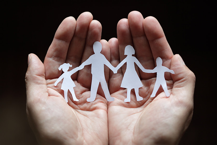 Palm holding cutout of family Palm holding cutout of family