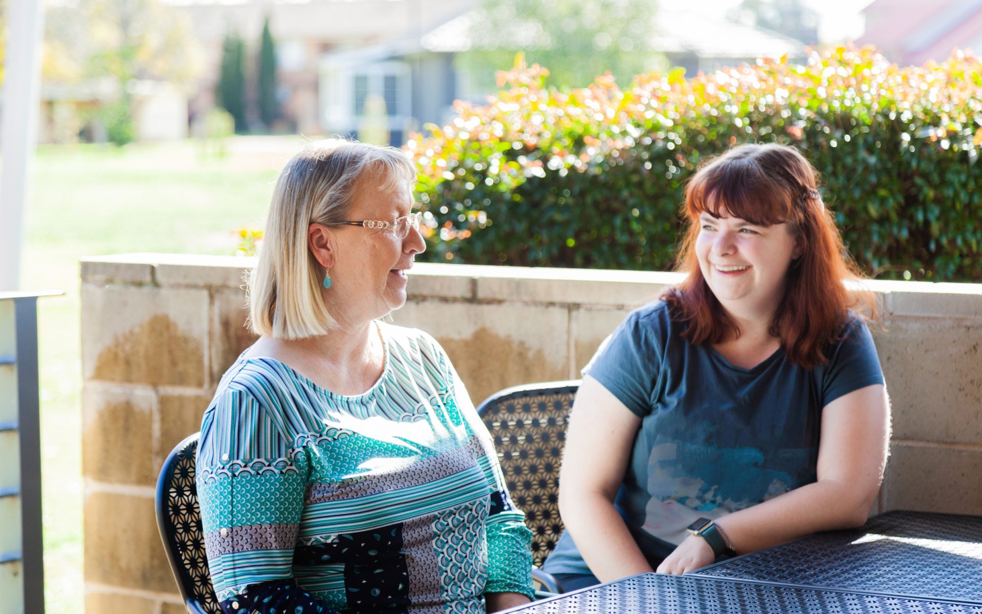 Women (5) two women sitting together outside