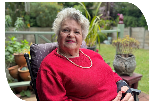 Older woman sitting in garden receiving support at home through in-home aged care services from Latrobe Community Health Services.