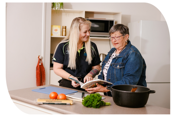 Support at Home worker assisting an older woman at home with cooking and shopping as part of in-home aged care services with Latrobe Community Health Service