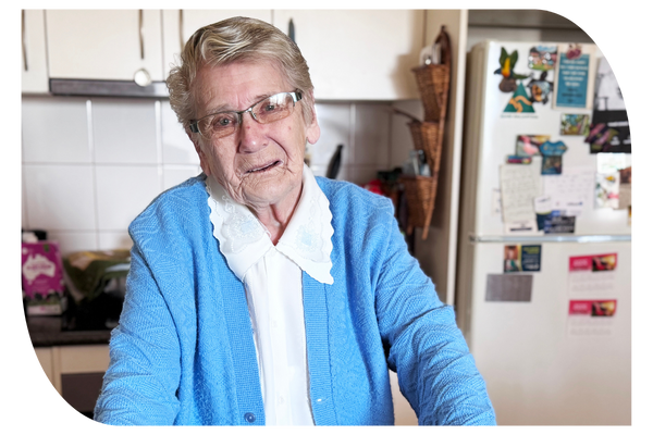 Older woman standing in her kitchen receiving support at home through in-home aged care services from Latrobe Community Health Services.