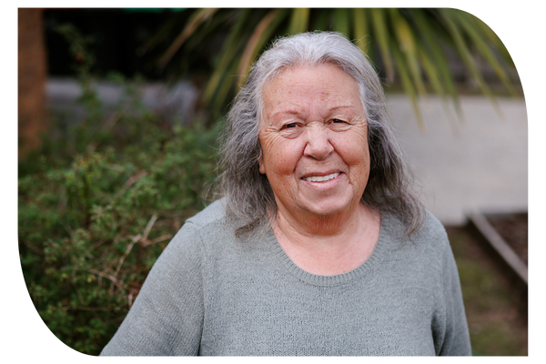 Older woman in her garden receiving support at home through in-home aged care services from Latrobe Community Health Services.